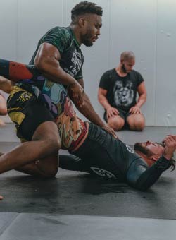 Close-up of a muscular, Caucasian male with brunette hair working mitts for muay thai.